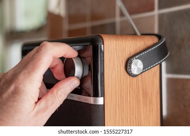 London, UK - Circa November 2019: Person Seen Tuning A Digital Streaming Radio In A Kitchen Area. The Radio Is Being Tuned Into A Popular, UK News And Current Affairs Channel. 