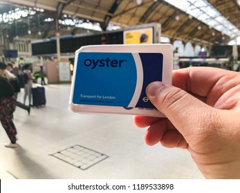 London, UK - Circa September, 2018: Man holding the Oyster Card for pay-as-you-go transaction for all public transport in London.