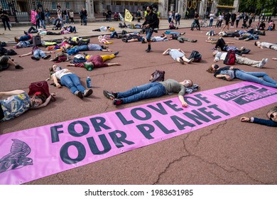 LONDON, UK – Circa September 2020: Extinction Rebellion demonstrators lay down on the pavement during a peaceful climate change protest at Buckingham Palace.