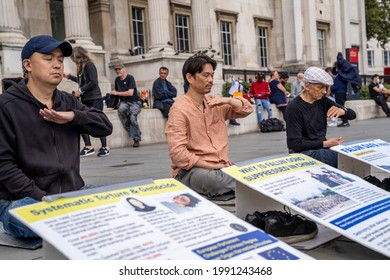 LONDON, UK – Circa September 2020: Asian Men Meditate During A Demonstration Against The Persecution And Torture Of Falun Gong Practitioners By The Communist Party Of China