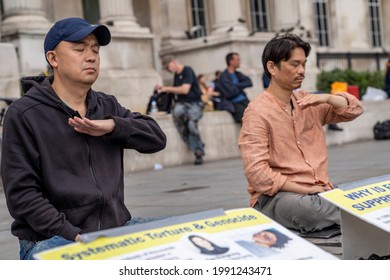 LONDON, UK – Circa September 2020: Asian Men Meditate During A Demonstration Against The Persecution And Torture Of Falun Gong Practitioners By The Communist Party Of China