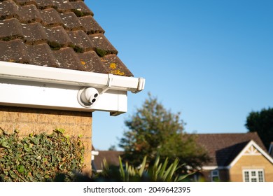 London, UK - Circa September 2021: Newly installed, dome type night and day colour CCTV camera attached to the eaves of a private bungalow. One of a number of cameras to monitor a cul-de-sac.