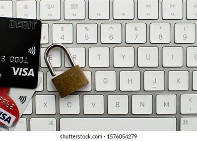 London, UK - CRICA DEC 2019: Online Banking Concept With Unlocked Padlock On Keyboard Next To Visa Card