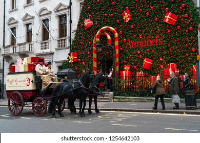 LONDON, UK - DECEMBER 08, 2018: Famous private club Annabel's in Berkeley Square, London decorates entrance into the building with a giant Christmas tree
