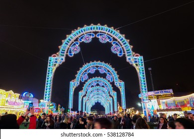 LONDON, UK - DECEMBER 14, 2016: People at Winter Wonderland in Hyde park enjoy taking a photo with The luminaires at night during Christmas and New years celebrations in London, United Kingdom.