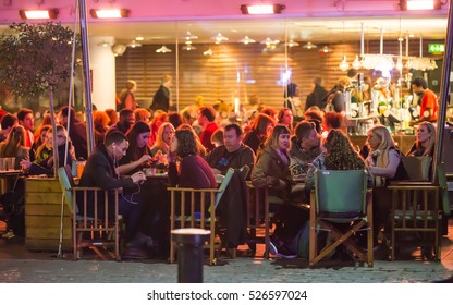 London, UK - December 19, 2015:  People In The Restaurant, Well Lit Up Outside Patio