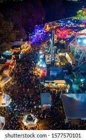 London, UK. December 2, 2019. London Wonderland. Night view of people walking in the Hyde Park's winter Wonder Land between different rides and attractions. Beautiful Christmas spirit in London.