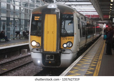 London, UK - December 25, 2016: Stansted Express / Greater Anglia Class 379 Train Approaching Tottenham Hale Station In London