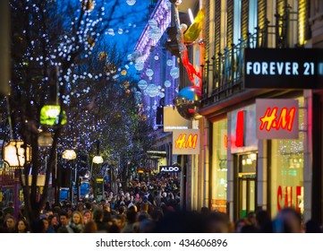 LONDON, UK - DECEMBER 30, 2015: Christmas lights decoration at Oxford street and lots of people walking during the Christmas sale, public transport, buses and taxies