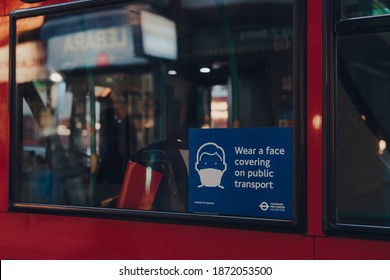 London, UK - December 5, 2020: Wear A Face Mask Sign On The Window Of A Red Double Decker Bus In London. The Requirements Were Introduced Due To Coronavirus Pandemic. 