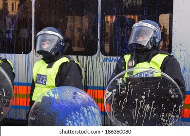 LONDON, UK - DECEMBER 9, 2010: Paint Splattered Riot Police Protect Parliament During Student Protests.