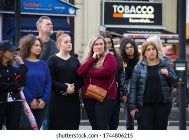 London, UK, England - 09.19.2020: Spectators Watching Street Performance In Piccadilly Circus. Real People On The Street, Real People Group, Street Crowd