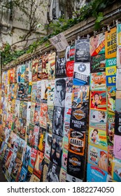 London, UK - February 14, 2020: Music And Classic Publicity Signs For Sale In Notting Hill. Signs Sale On Wall With Plants And Trees Behind It. Rock And Roll Memorabilia