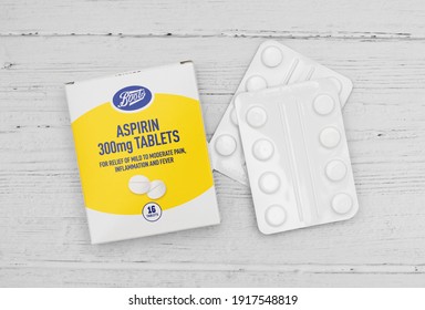 London UK - February 15th 2021 - Aspirin Packet And Tablets On A Wooden Table, 300mg Tablets From Boots Pharmacy