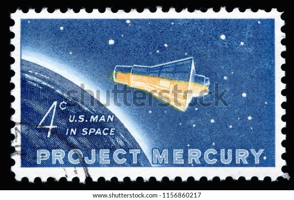 London, UK, February 19 2018 - Vintage 1962 United\
States of America 4 cents cancelled postage stamp showing  Project\
Mercury space flight