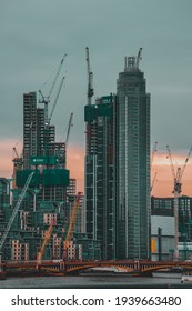 London UK February 2021 Massive Skyscrapers Beign Built On The West Part Of London, Seen From The City Center. Many Contruction Cranes Rising Above The Clouds And Above The River Thames