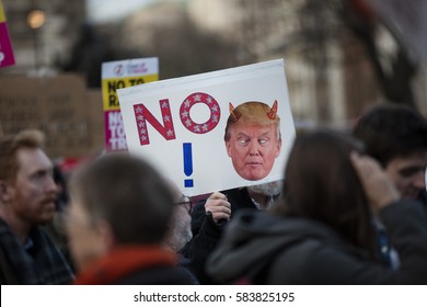 LONDON, UK - FEBRUARY 20th 2017: Protesters hold posters and banners at an anti Donald Trump protest in Parliament square, London. - Shutterstock ID 583825195