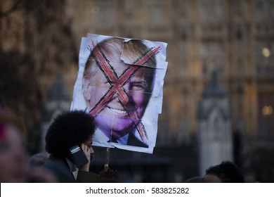 LONDON, UK - FEBRUARY 20th 2017: Protesters hold posters and banners at an anti Donald Trump protest in Parliament square, London.