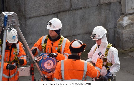 London, UK. February 26 2020. Three Male And One Female British Water Company Workers / Engineers Working On An Underground Water Mains Pipe In Central London.