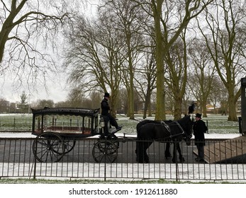 London, UK - February 8th 2021: Traditional East End Hearse Horse And Trap Funeral Carriage In The London Snow