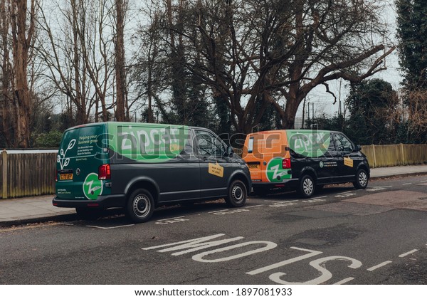 London, UK - January 01, 2021: Zipcar vans parked\
on a street in Muswell Hill, North London. Zipcar is a car-sharing\
company and a popular alternative to traditional car ownership in\
London.