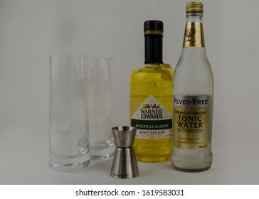 London, UK - January 17 2020 - Warners Honeybee Gin With A Fever Tree Tonic Water, Two Glasses And A Shot Measurer