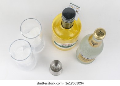 London, UK - January 17 2020 - Warners Honeybee Gin With A Fever Tree Tonic Water, Two Glasses And A Shot Measurer