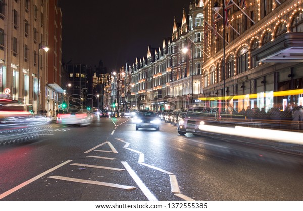 London,\
Uk, january 2019. Night city view, a characteristic detail of the\
busy city life, taxis, people and wet\
streets.