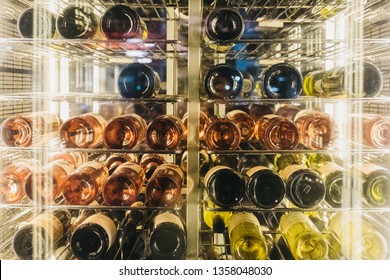 London, UK - January 26, 2019: Close Up Of Rows Of White, Red And Rose Wines On A Shelf In A Restaurant Fridge, View Through The Glass. Wine Is One Of The Most Popular Alcoholic Drinks In UK. 