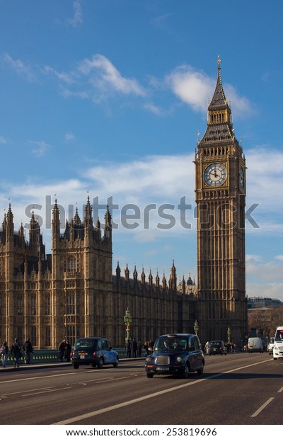 London,\
UK - January 30, 2015: London Taxi and Big Ben in far behind on\
Westminster bridge on Jan 30, 2015 in London,\
UK.