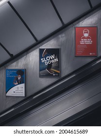 LONDON, UK - JANUARY 30, 2021: Classic advertisements of a London station. Located at the walls of the escalators making reference of wear a mark during the pandemic moment