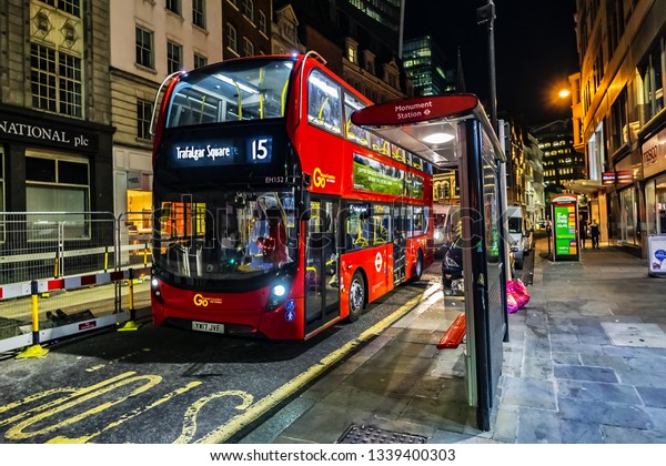 LONDON, UK - JULY 14, 2018: Red Double\
Decker Bus 15 line at the bus stop at night in London. Red Double\
Decker Bus is one of the most iconic symbols of\
London.