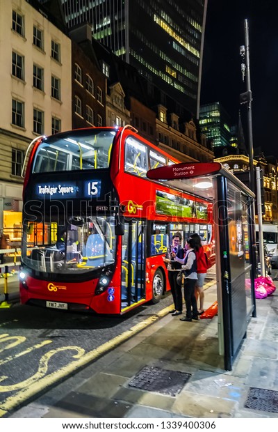 LONDON, UK - JULY 14, 2018: Red Double\
Decker Bus 15 line at the bus stop at night in London. Red Double\
Decker Bus is one of the most iconic symbols of\
London.