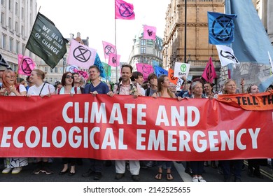 London, UK. July 15th 2019. The Climate Change Action Group Extinction Rebellion Members Seen Protesting Behind A Large Red Banner And Waving Flags During A Protest March In Central London In 2019.