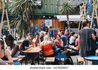 London, UK - July 16, 2019: People At The Tables Inside Pop Brixton, Event Venue And The Home Of A Community Of Independent Retailers, Restaurants, Street Food Startups And Social Enterprises.