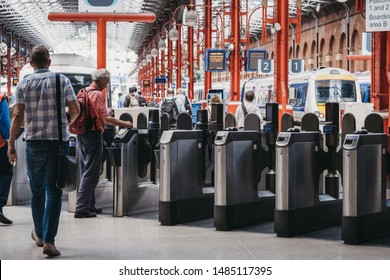 London, UK - July 18, 2019: People At Gates Inside Marylebone Station In London. The Station Was Opened In 1899 For Great Central Main Line, The Last Major Railway To Open In Britain In Over 100 Years