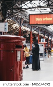 London, UK - July 18, 2019: Post Box Inside Marylebone Station In London, People Behind. The Station Was Opened In 1899 For Great Central Main Line, Last Major Railway To Open In UK In Over 100 Years.