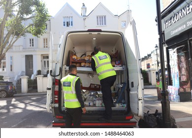 London UK - July 2019 Men Wearing Hi-vis  In White Van Delivering Milk To A Corner Shop 