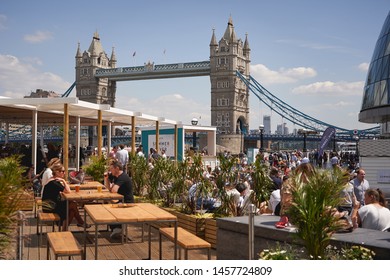 London, UK - July, 2019. People Having Drinks In A Pop-up Bar Created For The Summer By The River Event Held Close To City Hall And Tower Bridge.