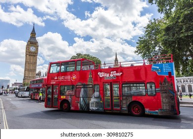 LONDON, UK - JULY 21, 2015: London city tour bus passing Parliament Square. This is one of the best ways to enjoy most of London in a short time.