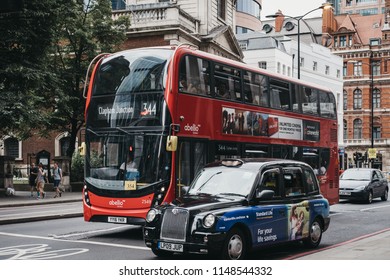 London, UK - July 22, 2018: Red Double Decker Buses And Black Cab Waiting On Traffic Light In London. Red Double Decker Are Recognised Worldwide As The Icons Of The City.