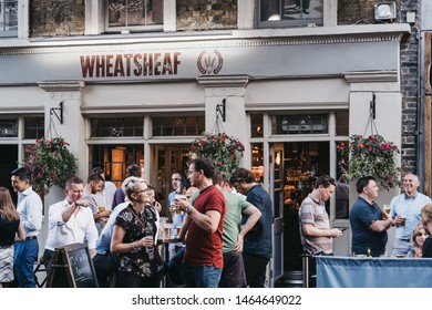 London, UK - July 23, 2019: People Drinking Outside Wheatsheaf Pub In Borough Market, One Of The Largest And Oldest Food Markets In London.