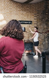 London, UK - July 26, 2018: People Taking Photos By 9 3/4 Platform Inside King's Cross Station, London, Station Where Students Of Hogwarts School Catch The Hogwarts Express.