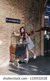 London, UK - July 26, 2018: People Taking Photos By 9 3/4 Platform Inside King's Cross Station, London, Station Where Students Of Hogwarts School Catch The Hogwarts Express.