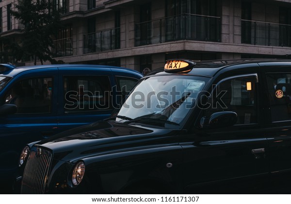 London, UK - July 26, 2018:\
Close up of an illuminated taxi sign on a black cab in London, UK.\
London taxis are an important part of the capital\'s transport\
system.