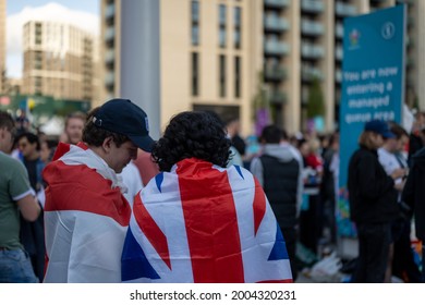 London, UK - July 7 2021: Two England Fans Wear Flags Outside Wembley Stadium Ready For The Euro 2020 Final