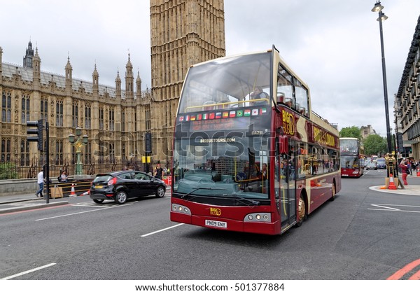 LONDON, UK - JULY 8, 2016: London tour bus on\
Westminster bridge. Open-top tour bus with audio guide, various\
languages available, is the great way see the London\'s major sights\
in short time.