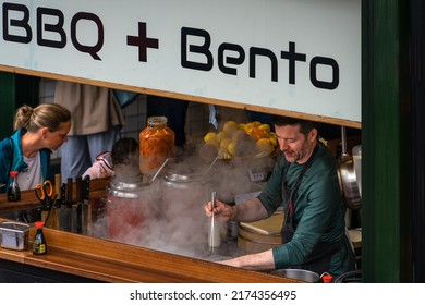 London, UK - Jun 09 2022: Man Cooking At A Street Food Pavilion At Borough Market, London 