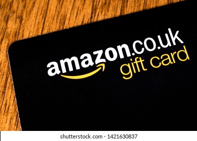 London, UK - June 11th 2019: An Amazon gift card pictured on a wooden surface.