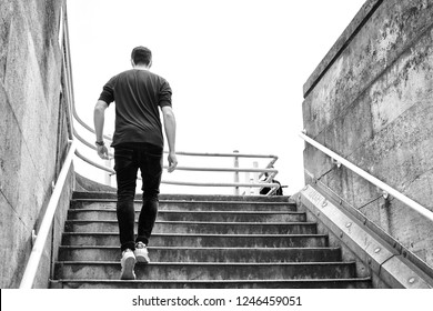 London, UK - June 15 2018: Young Man Wearing Casual Clothes Climbing The Stairs. Success And Business Concept. 